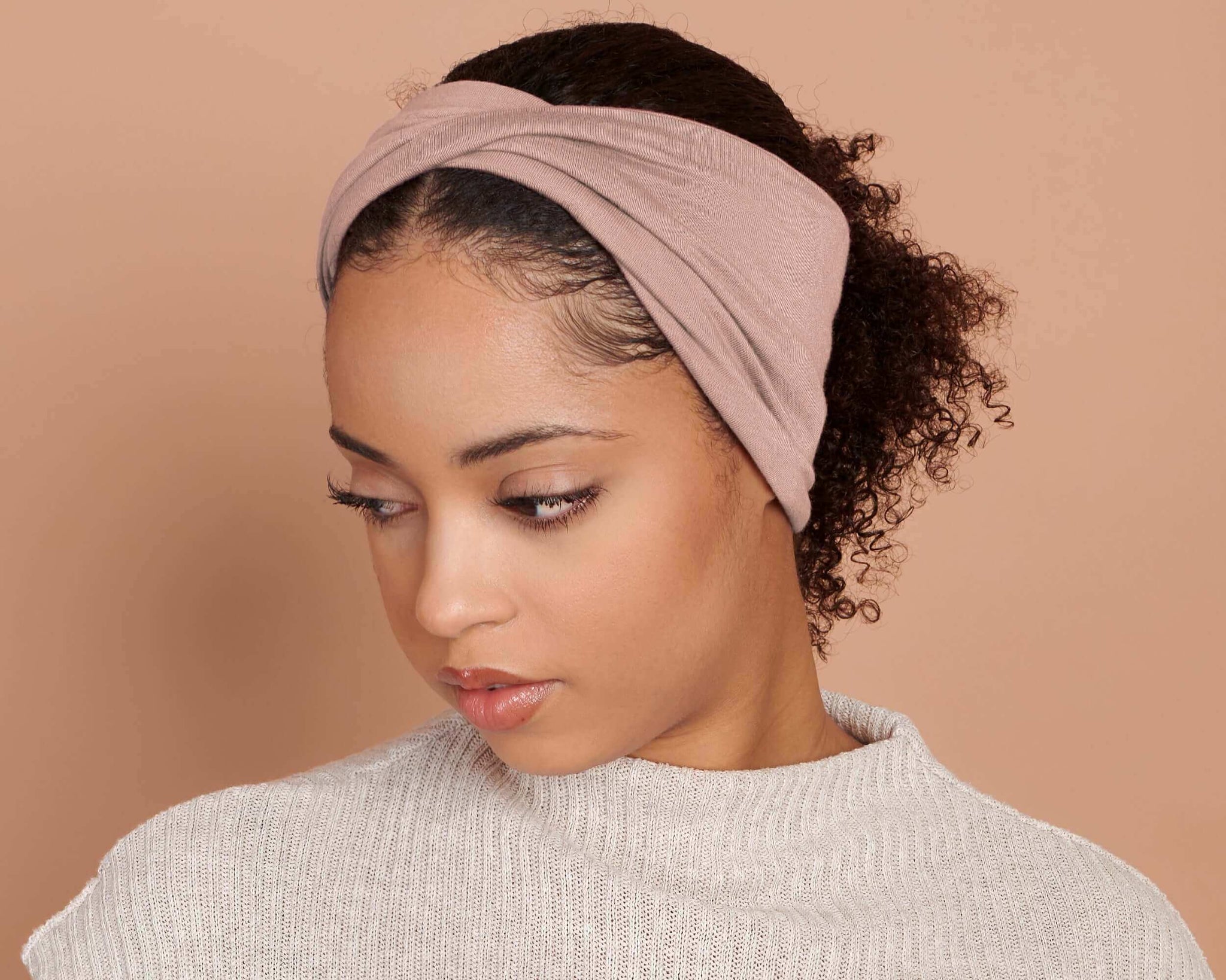 women wearing a Cocoa Rose Blush Twist Stretch Headband