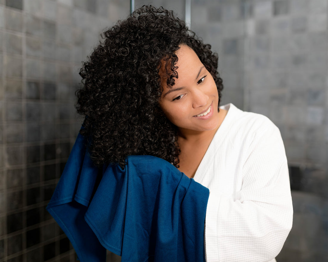 Woman using a Royal Blue T-Shirt Hair Towel for Curly, Wavy, and Straight Hair - Soft, Absorbent and Eco-Friendly