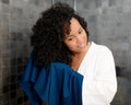 Woman using a Royal Blue T-Shirt Hair Towel for Curly, Wavy, and Straight Hair - Soft, Absorbent and Eco-Friendly