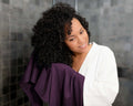 woman using a Plum T-Shirt Hair Towel for Curly, Wavy, and Straight Hair - Soft, Absorbent, and Eco-Friendly