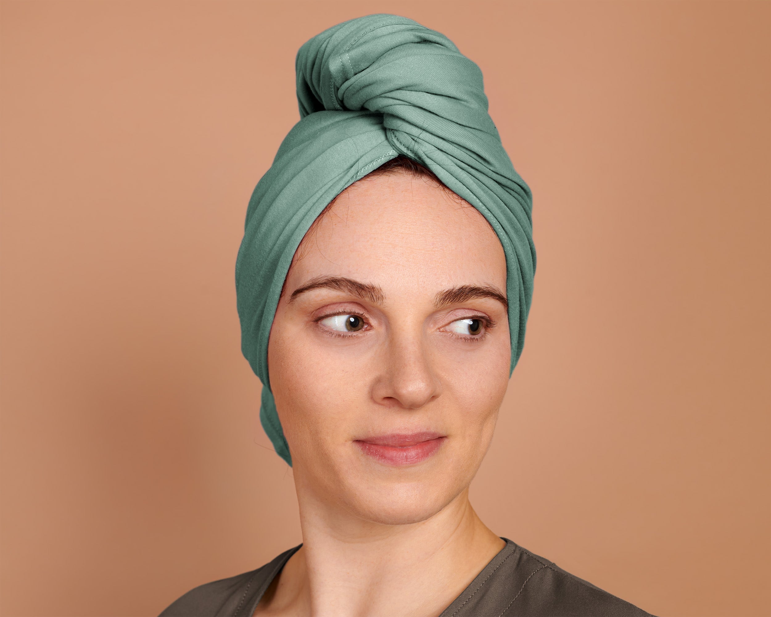 Woman using a T-Shirt Hair Towel for Curly, Wavy, and Straight Hair - Soft, Absorbent, and Eco-Friendly in jade green