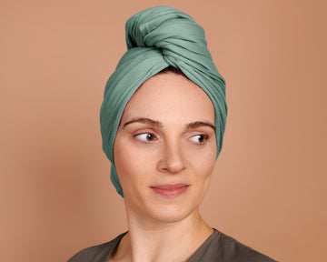 Woman using a T-Shirt Hair Towel for Curly, Wavy, and Straight Hair - Soft, Absorbent, and Eco-Friendly in jade green