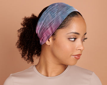 Woman wearing a Boho Headband Extra Wide, in Tie Dye, against a beige background