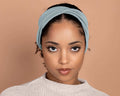 Woman wearing a Winter Sky Blue Twist Stretch Headband