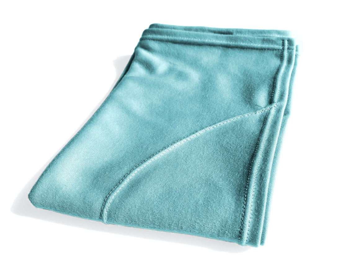 Woman with curly hair plopping a T-Shirt Hair Towel for Curly, Wavy, and Straight Hair - Soft, Absorbent, and Eco-Friendly in Aqua Blue,  in a bathroom setting