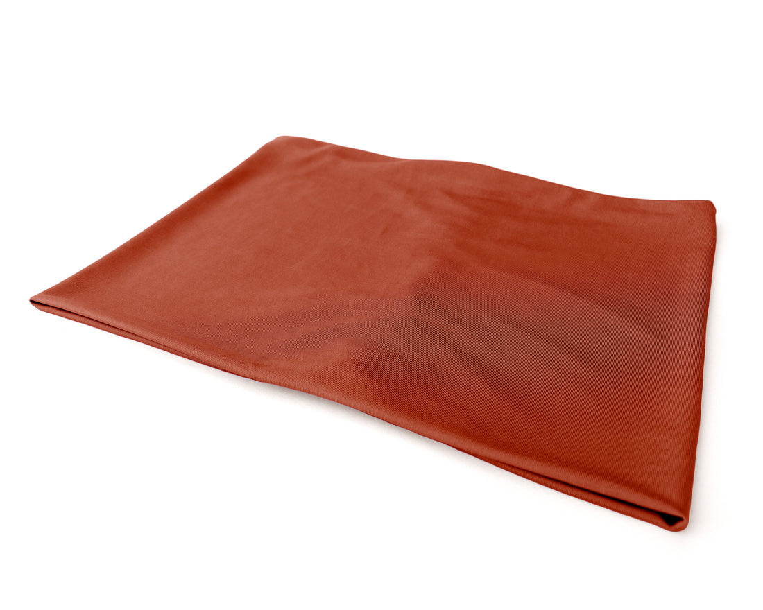 Woman wearing a Boho Headband Extra Wide in Burnt Orange, against a beige background