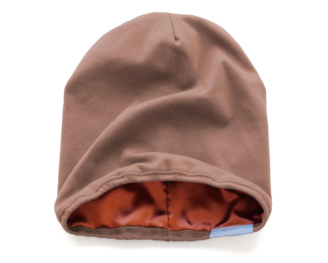 woman wearing a Mocha Taupe Satin Lined Beanie for Women and Men - Soft and Warm Beanie with Satin Lining to Protect Hair