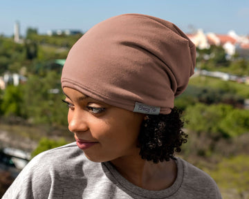 woman wearing a Mocha Taupe Satin Lined Beanie for Women and Men - Soft and Warm Beanie with Satin Lining to Protect Hair