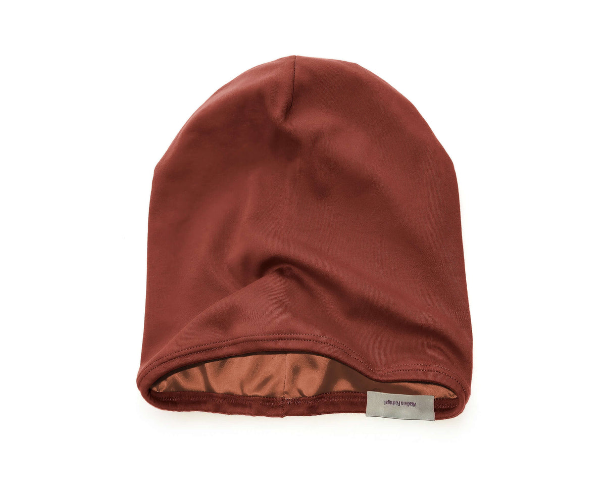 A Satin-Lined Beanie for Women and Men - Soft and Warm Beanie with Satin Lining to Protect Hair in Burnt Orange, displayed against a solid white background.